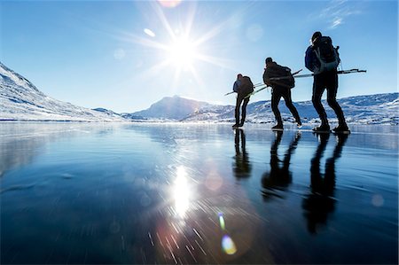 simsearch:6102-08520961,k - Three people skiing on frozen lake Stock Photo - Premium Royalty-Free, Code: 6102-08942647