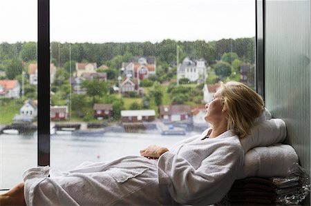 robe - Woman looking through window Stock Photo - Premium Royalty-Free, Code: 6102-08951509