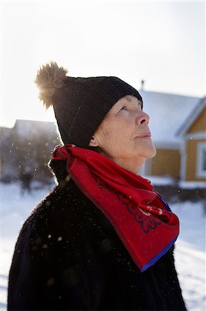 simsearch:6102-08000621,k - Senior woman standing in front of house in winter Stock Photo - Premium Royalty-Free, Code: 6102-08951952