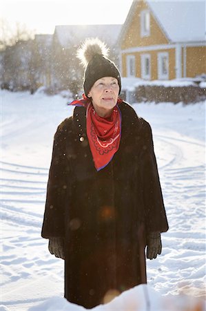 simsearch:6102-08000621,k - Senior woman standing in front of house in winter Stock Photo - Premium Royalty-Free, Code: 6102-08951955