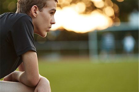 simsearch:6102-08000621,k - Side view of teenage boy sitting and looking away Stock Photo - Premium Royalty-Free, Code: 6102-08952003