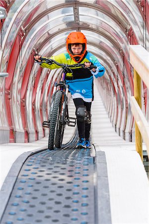 forward - Boy walking with bike through tunnel Stock Photo - Premium Royalty-Free, Code: 6102-08995367