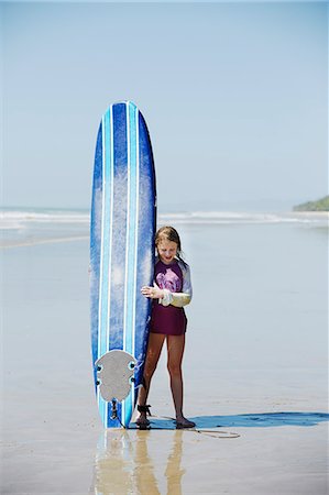simsearch:6102-08542382,k - Girl on beach with surfboard Stock Photo - Premium Royalty-Free, Code: 6102-08995986