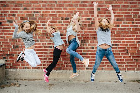 schoolyard - Happy girls jumping Stock Photo - Premium Royalty-Free, Code: 6102-08996010