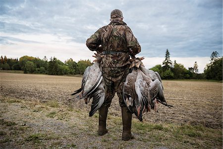 simsearch:6102-06337050,k - Hunter carrying dead geese Stock Photo - Premium Royalty-Free, Code: 6102-08996033