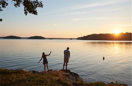 Young people fishing by lake Stock Photo - Premium Royalty-Free, Code: 6102-08996670