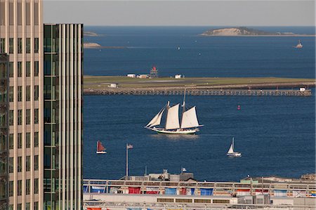 sailboat  ocean - Buildings at a harbor with boats in the background, Boston, Massachusetts, USA Stock Photo - Premium Royalty-Free, Code: 6105-05395955