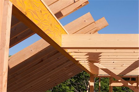 Low angle view of roof rafters with beams and joists Stock Photo - Premium Royalty-Free, Code: 6105-05396056
