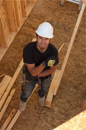 High angle view of a carpenter in house frame Foto de stock - Sin royalties Premium, Código: 6105-05396058