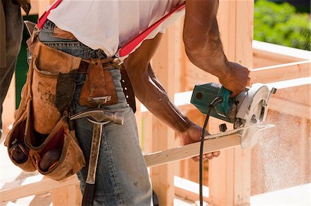 electric saw - Carpenter cutting bevel with a circular saw Stock Photo - Premium Royalty-Free, Code: 6105-05396091