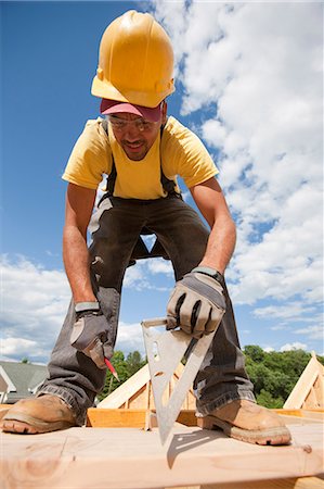 simsearch:693-06016727,k - Carpenter marking spacing of rafters with a pencil Stock Photo - Premium Royalty-Free, Code: 6105-05396033