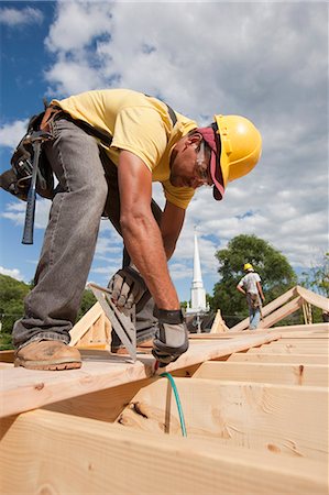 simsearch:6105-06043034,k - Carpenter marking spacing of rafters with carpenter triangle Stock Photo - Premium Royalty-Free, Code: 6105-05396032