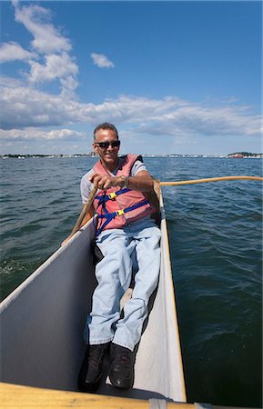 Man with spinal cord injury outrigger canoeing in the sea Stock Photo - Premium Royalty-Free, Code: 6105-05396389