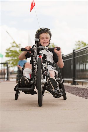 disable - Boy with cerebral palsy in a racing bike Stock Photo - Premium Royalty-Free, Code: 6105-05396319