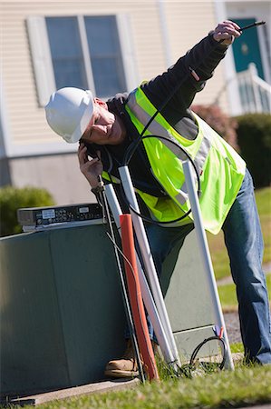 simsearch:6105-05953745,k - Cable installer working on wiring outside a house Stock Photo - Premium Royalty-Free, Code: 6105-05396589