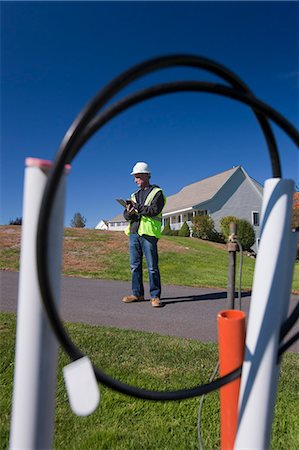 simsearch:6105-05953745,k - Cable installer working on wiring outside a house Stock Photo - Premium Royalty-Free, Code: 6105-05396591