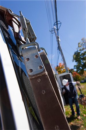 Safety harness hanging from the back of a cable installer's truck Stock Photo - Premium Royalty-Free, Code: 6105-05396595