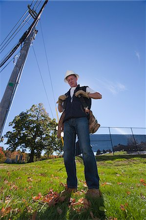 Engineer preparing to install equipment on a power pole Stock Photo - Premium Royalty-Free, Code: 6105-05396596