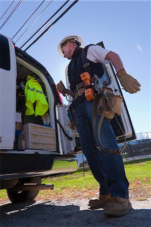 Engineer preparing to install equipment on a power pole Stock Photo - Premium Royalty-Free, Code: 6105-05396599
