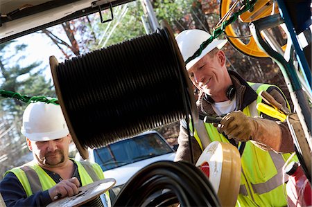 Cable reel with cable installers in the background Stock Photo - Premium Royalty-Free, Code: 6105-05396693