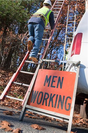 simsearch:6105-05953745,k - Cable installer climbing a ladder near a Men at Work sign Stock Photo - Premium Royalty-Free, Code: 6105-05396695