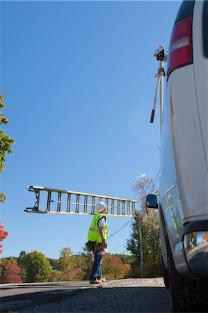simsearch:6105-05953745,k - Engineer carrying a ladder to climb power pole Stock Photo - Premium Royalty-Free, Code: 6105-05396600