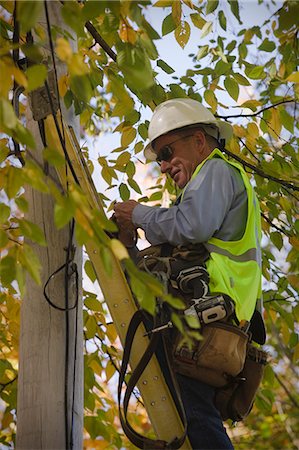 Engineer installing equipment on a power pole Stock Photo - Premium Royalty-Free, Code: 6105-05396609