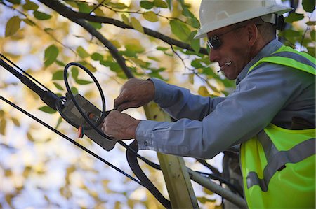 simsearch:6105-05953745,k - Engineer installing channel filter at a cable distribution box on a power pole Stock Photo - Premium Royalty-Free, Code: 6105-05396614