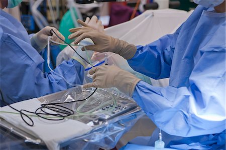 Surgical technologist passing a phaco hand piece to doctor during cataract surgery Stock Photo - Premium Royalty-Free, Code: 6105-05396745