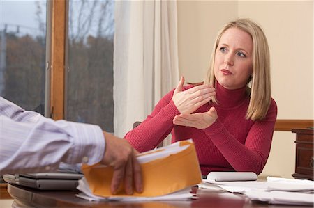 Woman signing the word 'Mortgage' in American Sign Language while communicating with a man Stock Photo - Premium Royalty-Free, Code: 6105-05396785