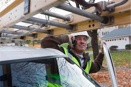 simsearch:6105-05953745,k - Cable installer talking on a mobile phone in a truck Stock Photo - Premium Royalty-Free, Code: 6105-05396701