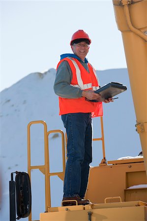 dump truck - Engineer with electronic clipboard on an earth mover Stock Photo - Premium Royalty-Free, Code: 6105-05396886