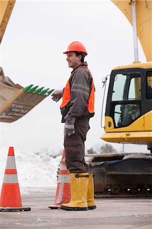 survey - Transportation engineer directing an earth mover at a construction site Stock Photo - Premium Royalty-Free, Code: 6105-05396947