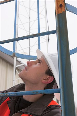 survey - Engineer climbing a tower with safety enclosure Stock Photo - Premium Royalty-Free, Code: 6105-05396960