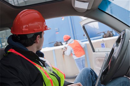 side view of man in truck - Engineer using a laptop in truck with an another engineer inspecting site Stock Photo - Premium Royalty-Free, Code: 6105-05396968
