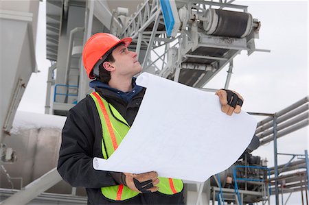 survey - Engineers holding a blueprint at a construction site Stock Photo - Premium Royalty-Free, Code: 6105-05396981