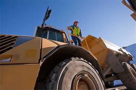 dump truck - Engineer on an earth mover at a construction site Stock Photo - Premium Royalty-Free, Code: 6105-05396918