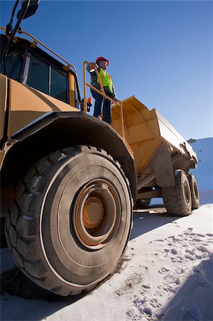 dump truck - Engineer on an earth mover at a construction site Stock Photo - Premium Royalty-Free, Code: 6105-05396919