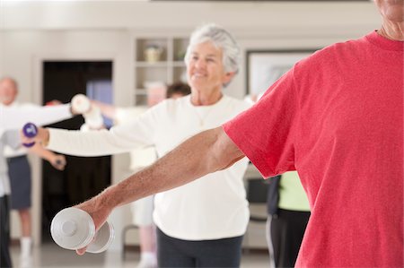 simsearch:6105-05397157,k - Seniors exercising with dumbbells in a health club Stock Photo - Premium Royalty-Free, Code: 6105-05397079