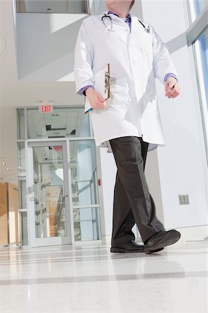 photos of us doctors - Male doctor walking in a corridor of a hospital Stock Photo - Premium Royalty-Free, Code: 6105-05397017