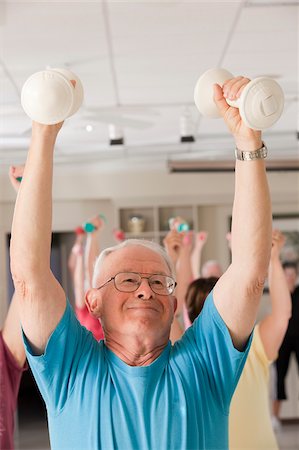 senior men at the gym - Senior exercise class doing arm stretches Stock Photo - Premium Royalty-Free, Code: 6105-05397148