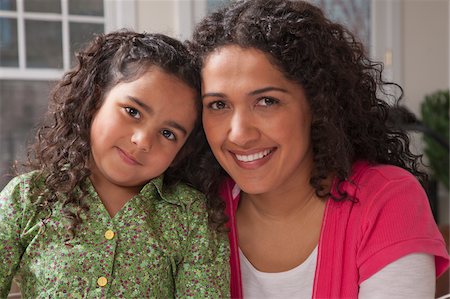 simsearch:695-03374346,k - Hispanic woman smiling with her daughter Stock Photo - Premium Royalty-Free, Code: 6105-05397189