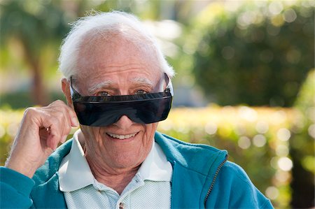 Portrait of a senior man wearing cataract dark glasses Stock Photo - Premium Royalty-Free, Code: 6105-05397128