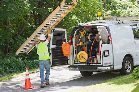 simsearch:6105-05953745,k - Lineman carrying a ladder back to his truck Stock Photo - Premium Royalty-Free, Code: 6105-05953743