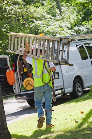 simsearch:6105-05953745,k - Lineman carrying a ladder back to his truck Stock Photo - Premium Royalty-Free, Code: 6105-05953742