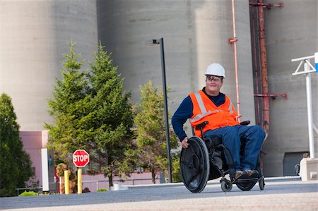 survey - Facilities engineer in a wheelchair inspecting outdoor bulk storage tanks Stock Photo - Premium Royalty-Free, Code: 6105-05953717