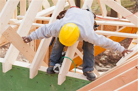 simsearch:6105-06043034,k - Carpenter lifting rafter for dormer Stock Photo - Premium Royalty-Free, Code: 6105-06043062