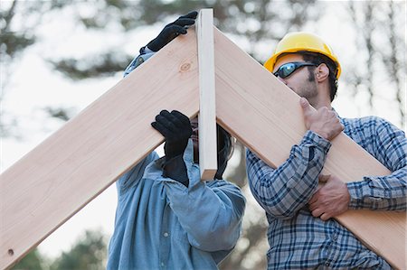 simsearch:6105-06043034,k - Carpenters placing rafters at peak Stock Photo - Premium Royalty-Free, Code: 6105-06043001