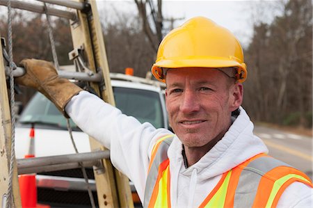 Power line worker with ladder at his truck Stock Photo - Premium Royalty-Free, Code: 6105-07521268