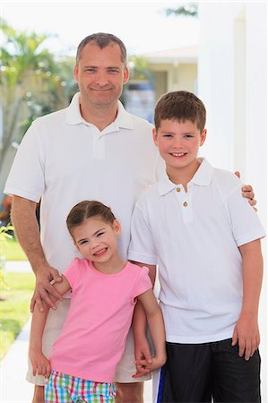 polo shirt - Man standing with his two children Stock Photo - Premium Royalty-Free, Code: 6105-07521358